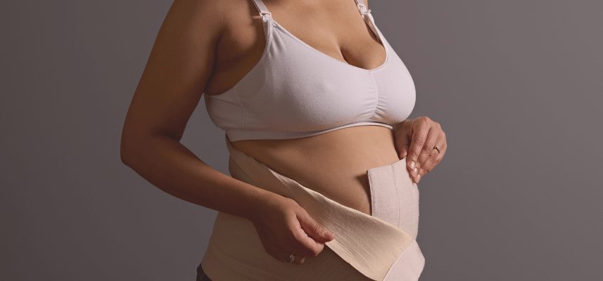 woman showing postpartum support garment